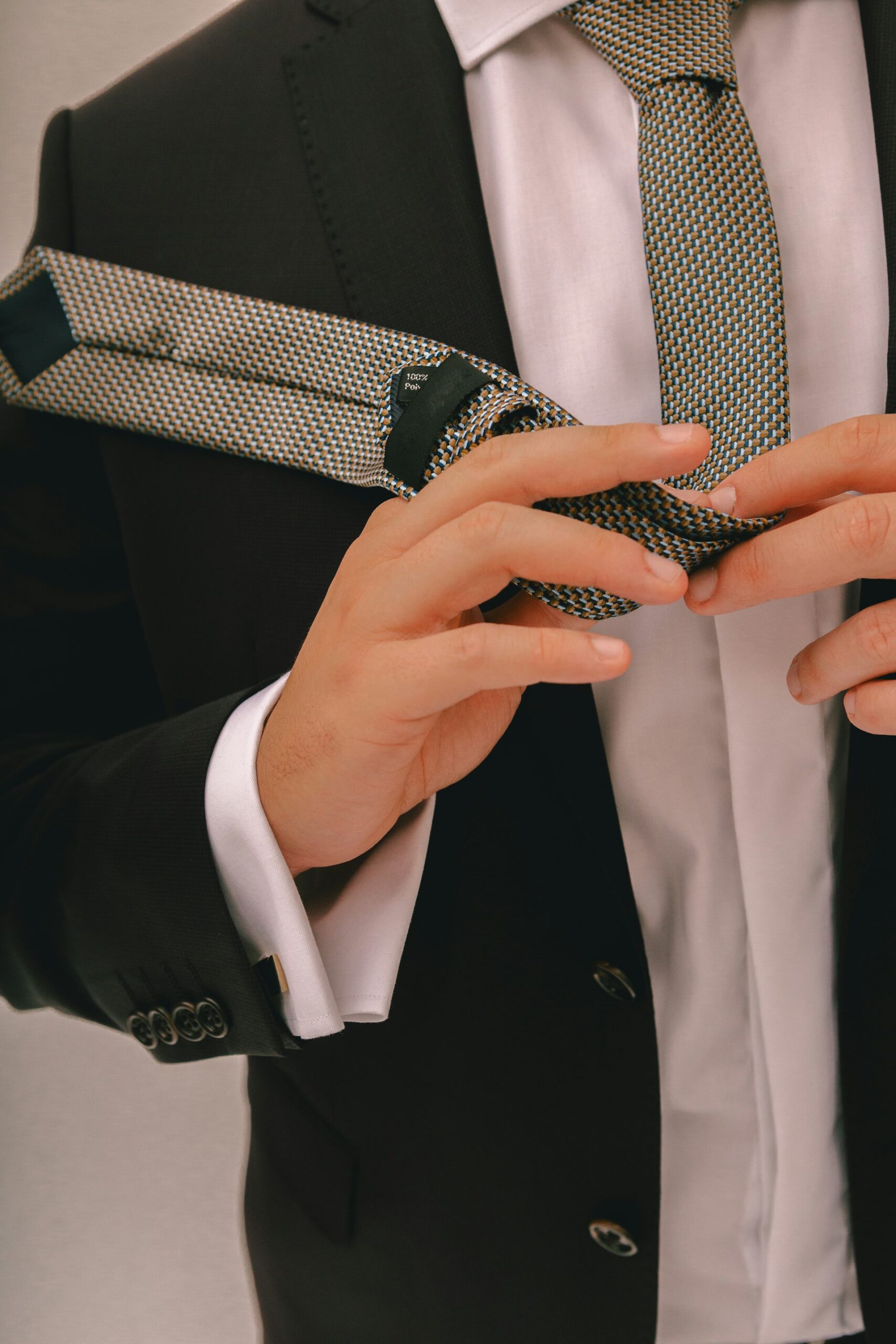 Man tying his tie - demonstrating proper technique